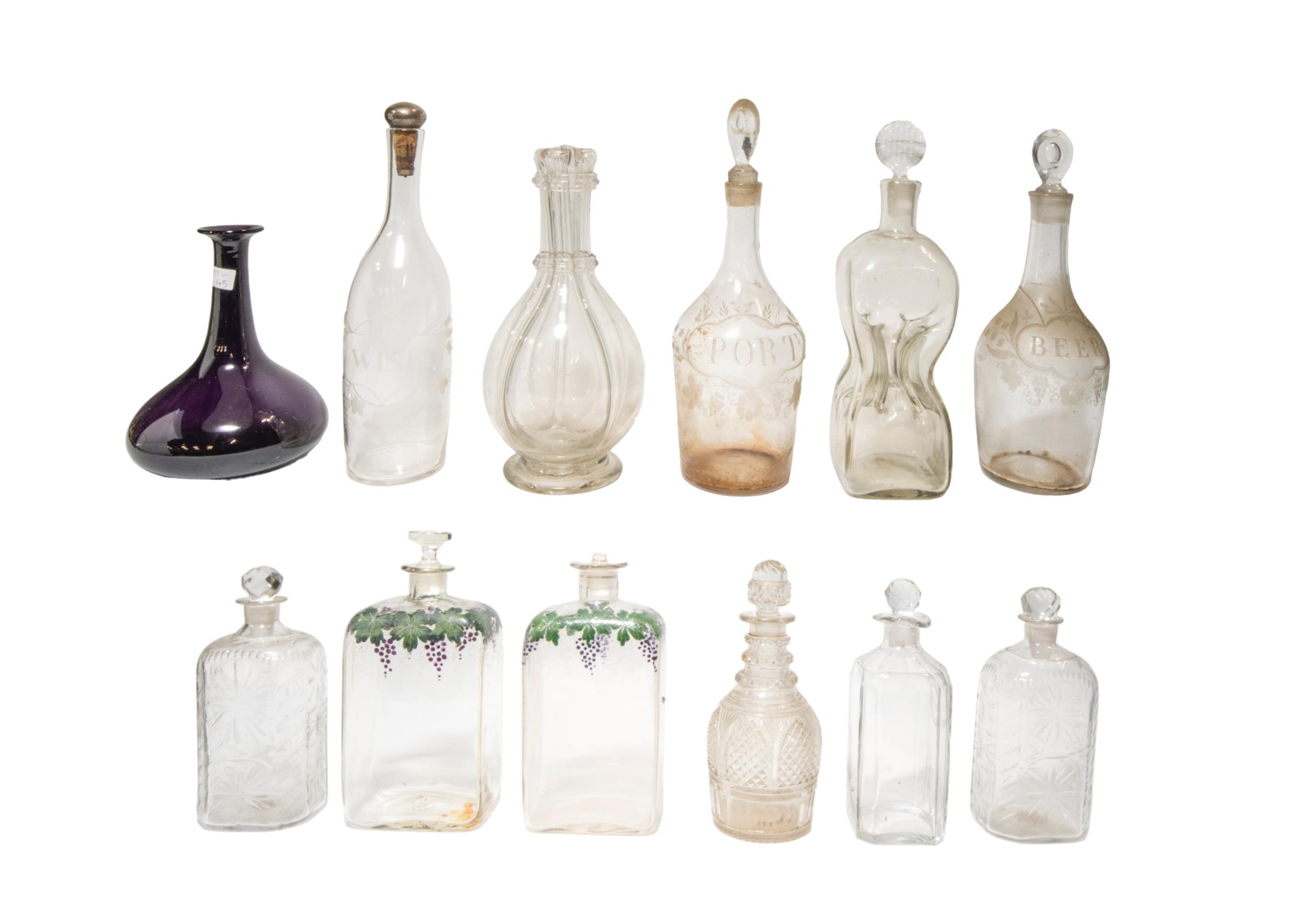 A MIXED GROUP OF ELEVEN VINTAGE GLASS DECANTERS, the lot includes an amethyst glass decanter, two