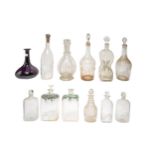 A MIXED GROUP OF ELEVEN VINTAGE GLASS DECANTERS, the lot includes an amethyst glass decanter, two
