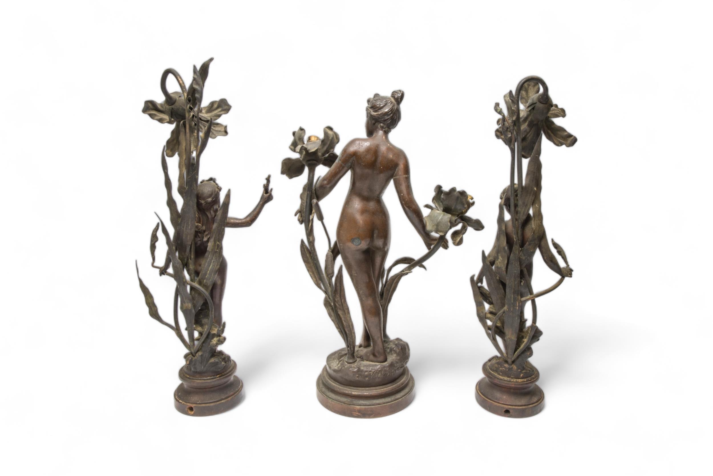 A PAIR OF COPPER ALLOY FRENCH ART NOUVEAU FIGURAL LAMPS AFTER MOREAU ON STONE BASES, and another