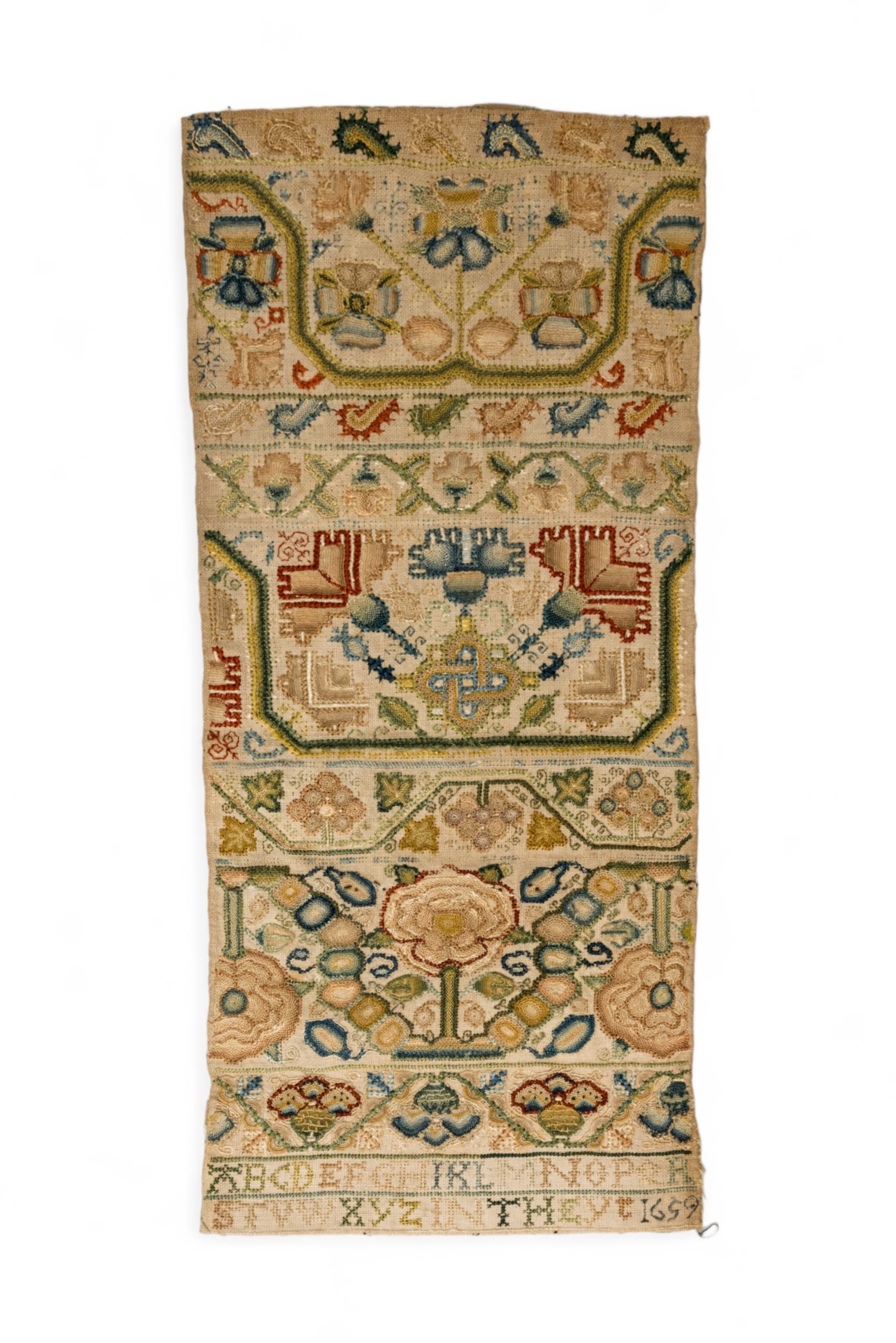 A 17TH CENTURY BAND SAMPLER the finely executed work with panels of flowers and meandering bands