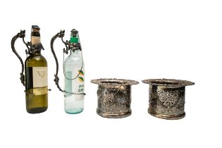 A PAIR OF VINTAGE WHITE METAL WINE BOTTLE HOLDERS, the handle and collar modelled as fruiting vines,