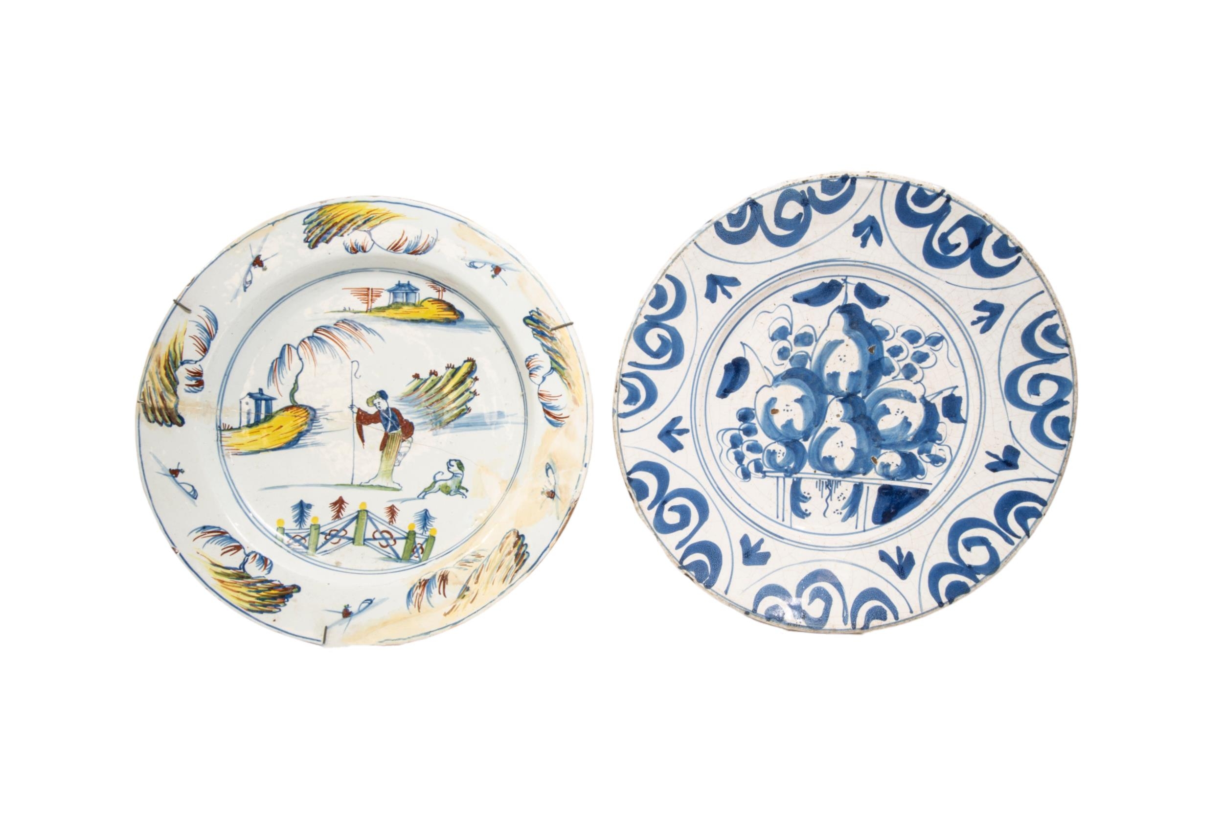 AN 18TH CENTURY DELFT DISH, the centre painted with fruits enclosed by scrolling reserves, along - Image 3 of 3