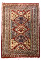 A HAND KNOTTED PERSIAN WOOL RUG, EARLY 20TH CENTURY, probably Bokhara (Pakistan/Afghan/Iranian