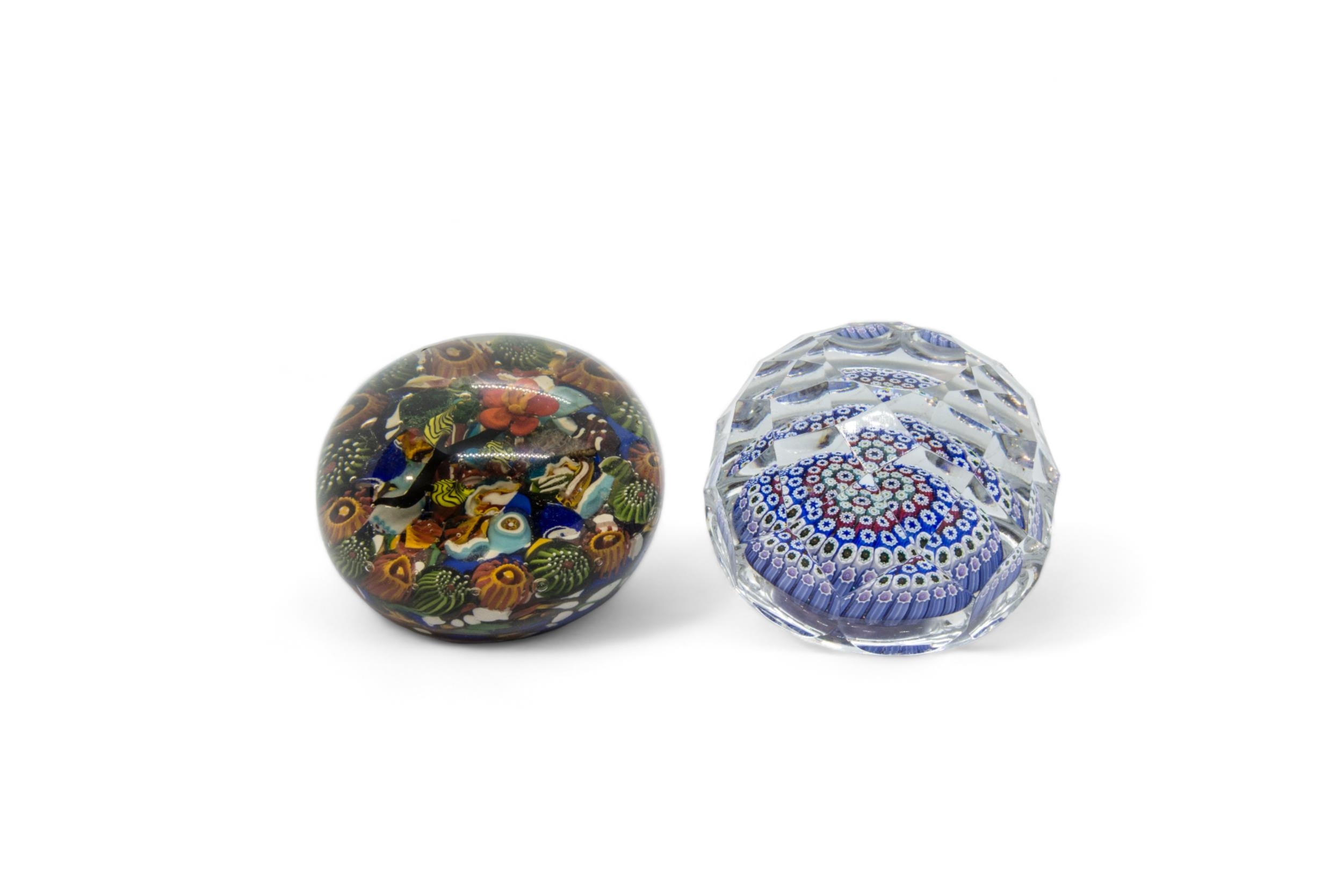 A WHITEFRIARS FACETED PAPERWEIGHT and a scrambled millefiori paperweight with lamp work flower,