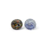 A WHITEFRIARS FACETED PAPERWEIGHT and a scrambled millefiori paperweight with lamp work flower,