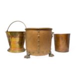 A COPPER AND BRASS COAL BIN with riveted detail and lions paw feet, a copper and brass banded coal