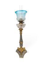 A GOOD 19TH CENTURY POLISHED STONE OIL LAMP with gilt tri-form platform base and mounts with cut
