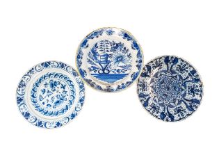 A GROUP OF THREE DUTCH DELFT DISHES, 18TH CENTURY, the lot includes one painted with a profusion