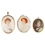 AN EDWARDIAN MINIATURE OF A RED HAIRED WOMAN, in a white metal and enamel frame, another in a 9ct