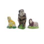 THREE EARLY STAFFORDSHIRE ANIMAL FIGURES Early 19th century, a seated monkey, recumbent lion and a