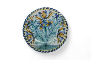 A BLUE DASH CHARGER Circa 1680-1700, painted with tulips and carnations, 33cms wide