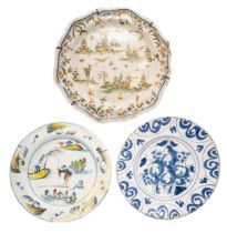 AN 18TH CENTURY DELFT DISH, the centre painted with fruits enclosed by scrolling reserves, along