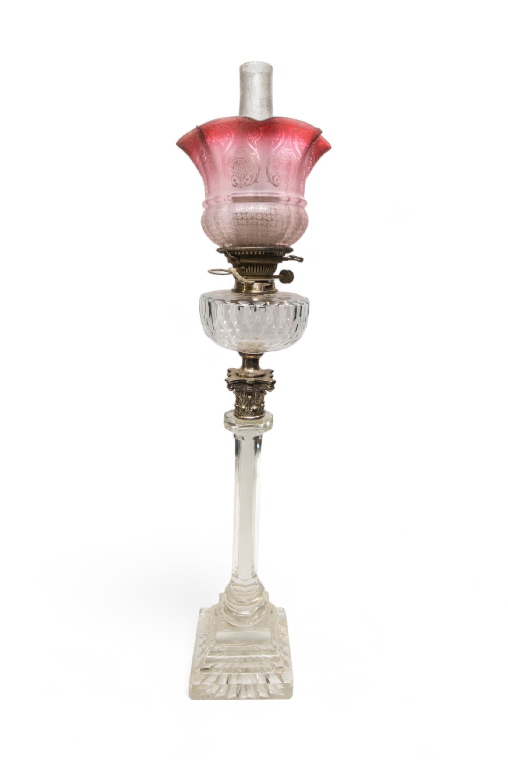 A VICTORIAN OIL LAMP, the hexagonal glass column with metal Corinthian column top with cut glass