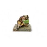 A 19TH CENTURY FIGURAL GROUP A boy sleeping next to a performing monkey, 13cms wide