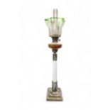 A VICTORIAN OIL LAMP with milk glass column upon a brass base with red glass reservoir and etched