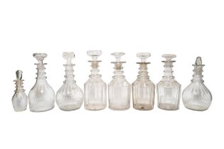 A MIXED GROUP OF SEVEN VINTAGE GLASS DECANTERS AND SAUCE BOTTLE, various sizes, all faceted and with