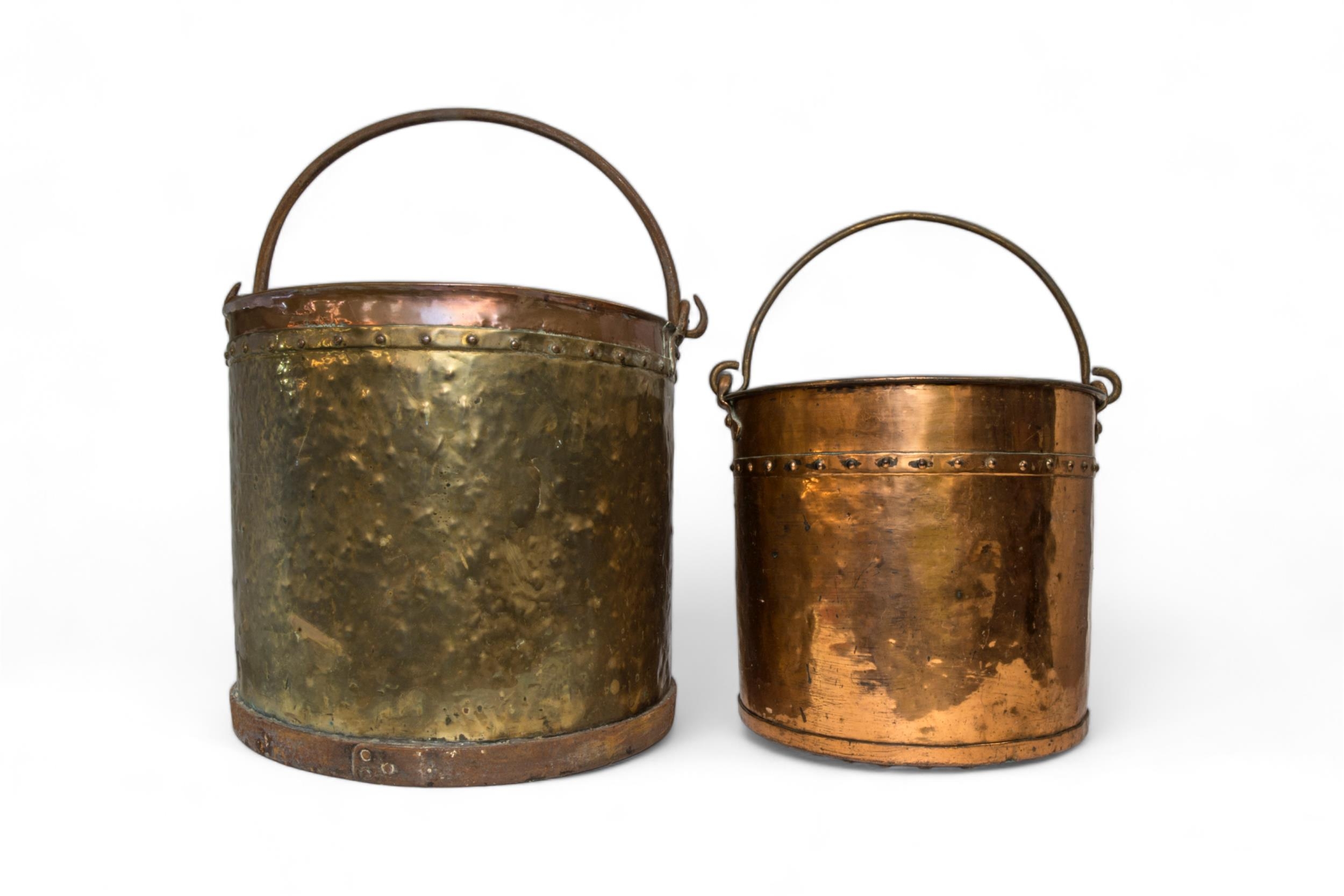 A LARGE COPPER AND BRASS COAL/LOG BUCKET with riveted border and swing handle and another smaller.