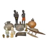 A CARVED WOODEN DAGGER SHEATH, a model of a South Seas outrigger, and various ethnographic ceramics,