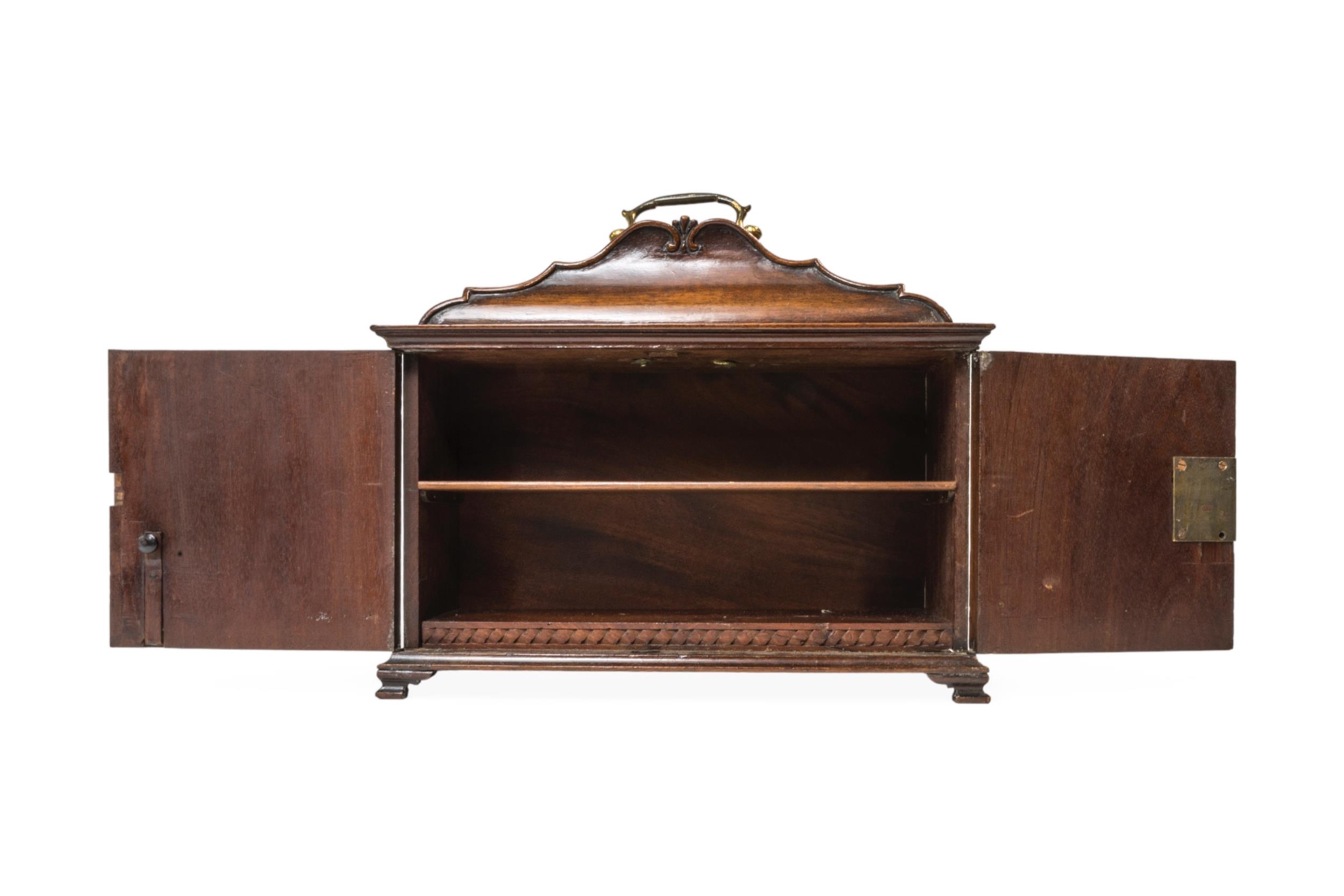A GEORGE III STYLE MAHOGANY TABLE-TOP 'CABINET', the shaped top with brass swing handle and two - Image 2 of 2