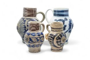 FOUR WESTERWALD STONEWARE JUGS Mid 18th century, all with 'GR' monogram, tallest is 23cms high.
