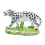 AN EARLY 19TH CENTURY LEOPARD On oval scroll base, 10.5cms