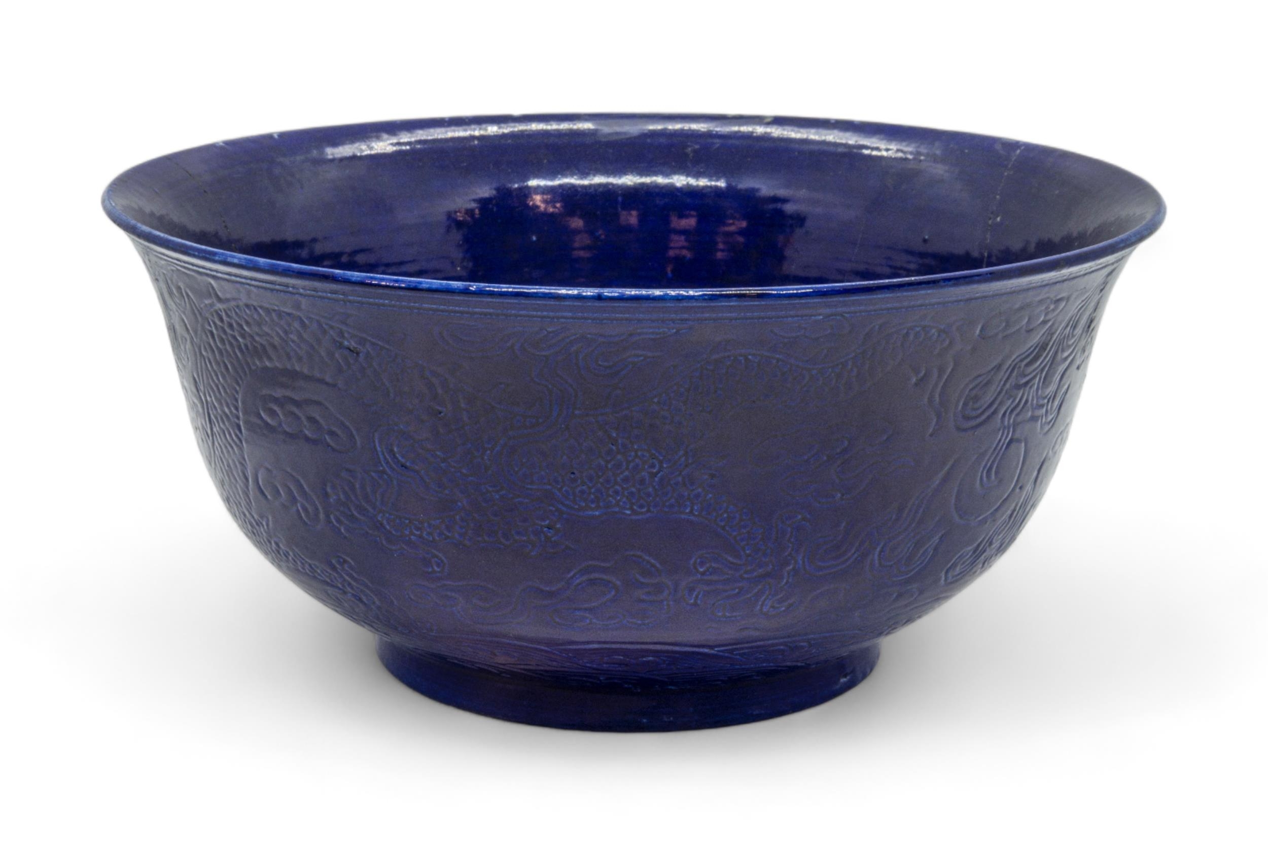 A CHINESE BLUE-GLAZED 'DRAGON' BOWL LATE QING DYNASTY bears an apocryphal Qianlong incised six