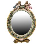 A MEISSEN PORCELAIN AND BRASS TABLE MIRROR, 19TH CENTURY, the oval form mirror surmounted by twin