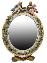A MEISSEN PORCELAIN AND BRASS TABLE MIRROR, 19TH CENTURY, the oval form mirror surmounted by twin