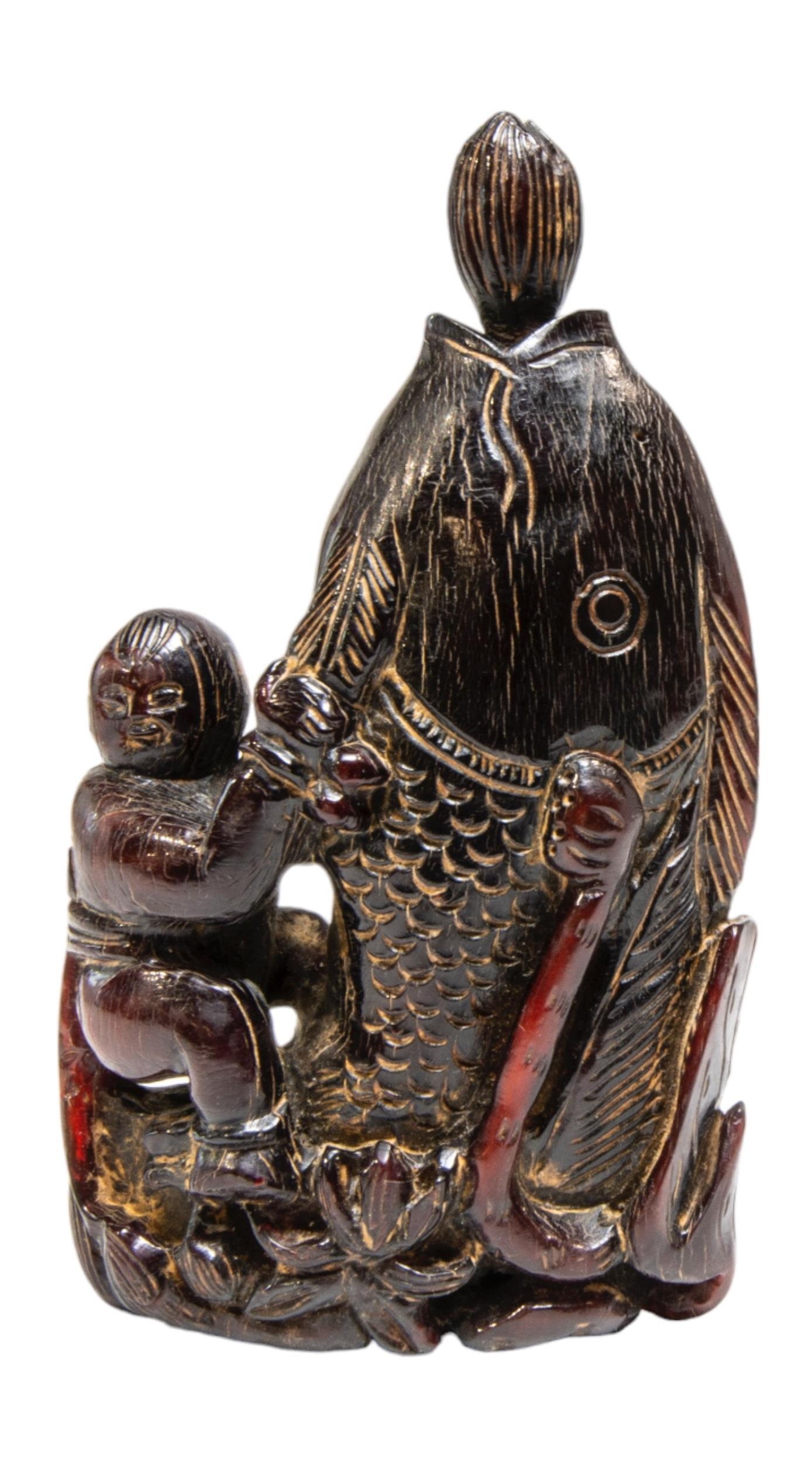 A JAPANESE CARVED HARDWOOD OKIMONO / FLASK, modelled as a fisherman astride a large fish, his