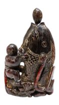 A JAPANESE CARVED HARDWOOD OKIMONO / FLASK, modelled as a fisherman astride a large fish, his