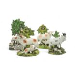 A PEARLWARE BOCAGE GROUP OF A SHEPHERDESS AND SHEEP Early 19th century, together with a pair of