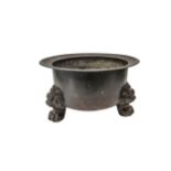 A CHINESE COPPER JARDINIERE, 19TH CENTURY, raised on three paw feet with lion head masks 24 cm