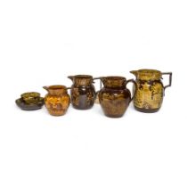 A GROUP OF YELLOW PRINTED CERAMICS Early 19th century, comprising four jugs and a tea bowl and