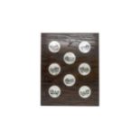 EIGHT MOTHER OF PEARL BUTTONS 19th / 20th century, mounted on oak board, 5cms