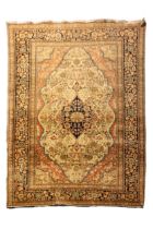 A HAND KNOTTED PERSIAN WOOL RUG, LATE 19TH / EARLY 20TH CENTURY, probably Kashan, slightly faded and