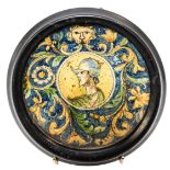 AN ITALIAN FAIENCE DISH, 17TH CENTURY, the central circular reserve painted with a portrait of a