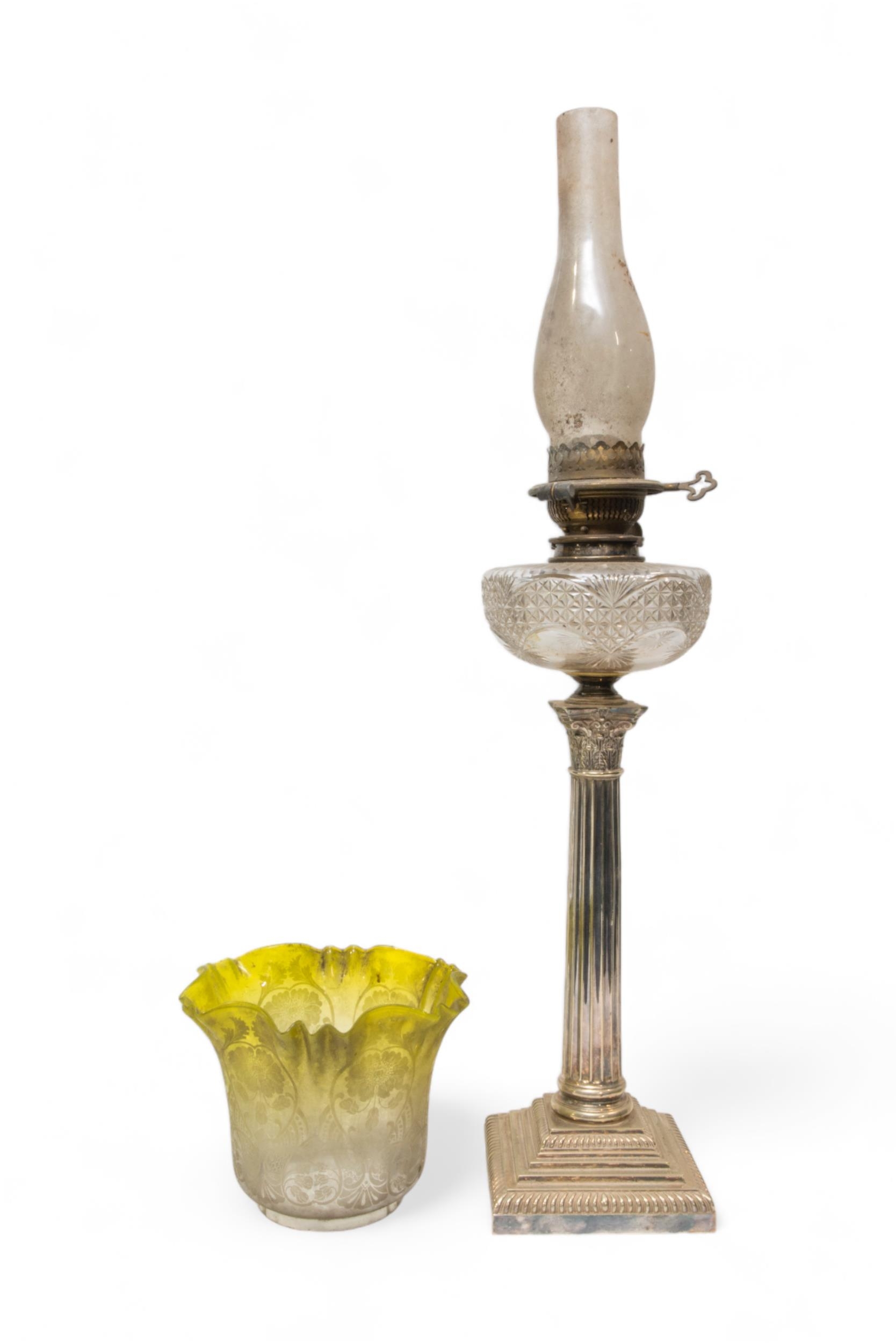 A VICTORIAN OIL LAMP, the silver plated corinthian column base with cut glass reservoir and brass