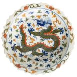 A CHINESE PORCELAIN DISH, the barbed edge rim with scroll foliate enamel painted decoration, the