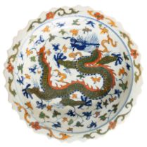 A CHINESE PORCELAIN DISH, the barbed edge rim with scroll foliate enamel painted decoration, the