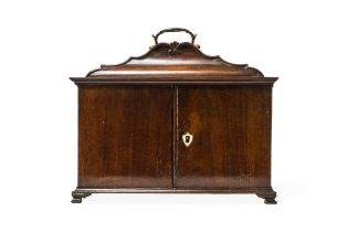 A GEORGE III STYLE MAHOGANY TABLE-TOP 'CABINET', the shaped top with brass swing handle and two