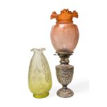AN OIL LAMP IN THE FORM OF A SMALL SILVER PLATED URN together with two etched glass shades, 25 cms