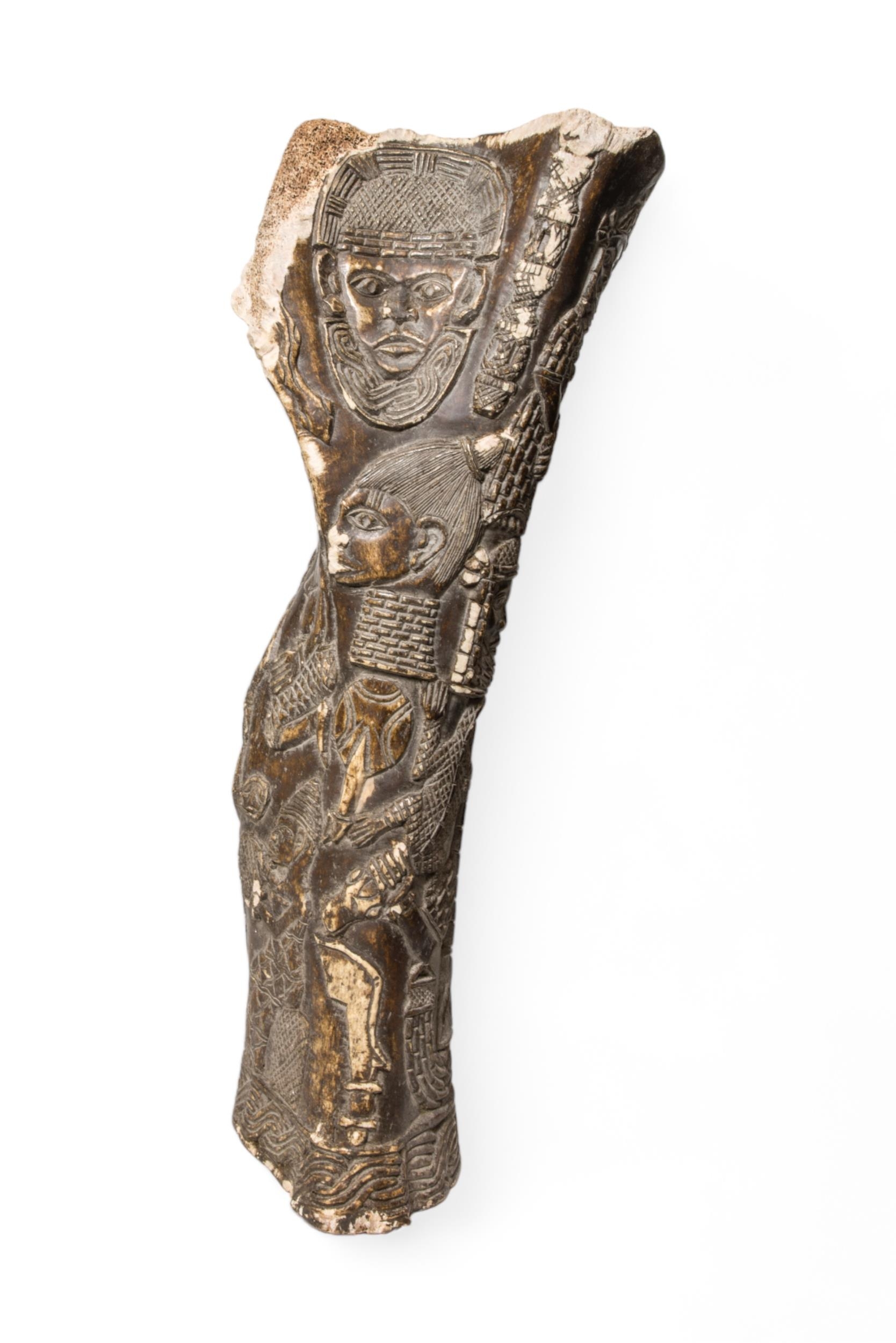 AN ELEPHANT LEG BONE WITH BENIN STYLE CARVINGS OF HIGH STATUS FIGURES 62cm