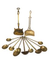 A VICTORIAN BRASS CREAM SKIMMER pierced and decorated with an eagle, another brass skimmer and a