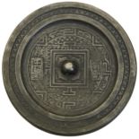 A CAST BRONZE MIRROR HAN DYNASTY (202BC - 220AD) a pierced knob centered within a square border,