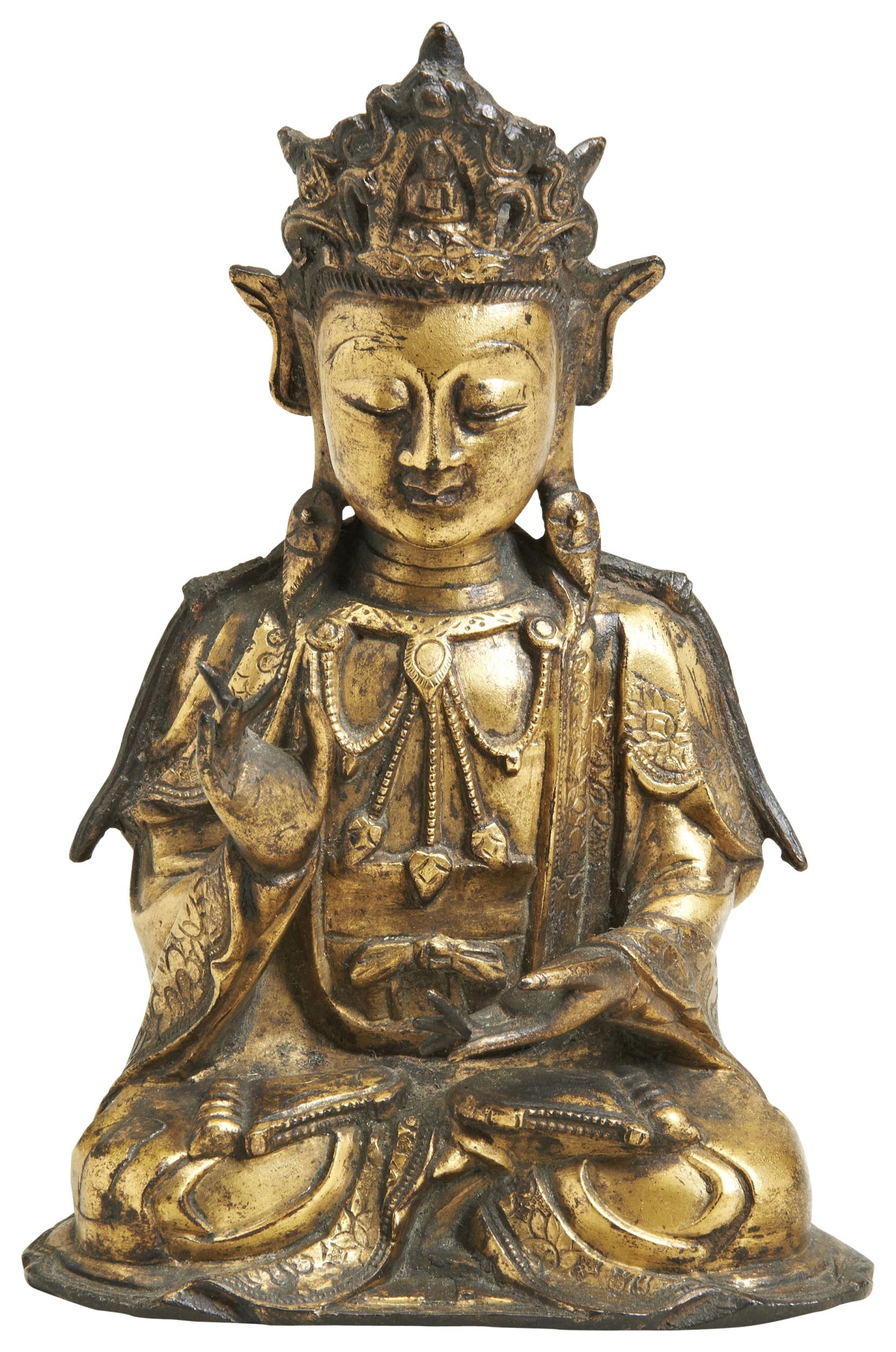 A GILT BRONZE FIGURE OF GUANYIN LATE MING DYNASTY seated in padmasana, dressed in long robes