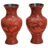 A PAIR OF CINNABAR LACQUER VASES LATE QING DYNASTY the baluster sides deeply carved with playful