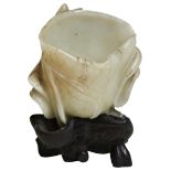 A CARVED WHITE JADE 'LOTUS LEAF' BRUSH WASHER QING DYNASTY, 18TH / 19TH CENTURY of naturalistic