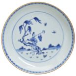 A BLUE AND WHITE DISH QING DYNASTY, 18TH CENTURY fienly painted with a figure seated beneath a