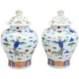 A PAIR OF DOUCAI 'PHOENIX AND CRANE' COVERED JARS QING DYNASTY, LATE 19TH CENTURY the baluster sides