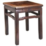 A CHINESE HARDWOOD STOOL QING DYNASTY (1644-1912) with natural wooden grain.
